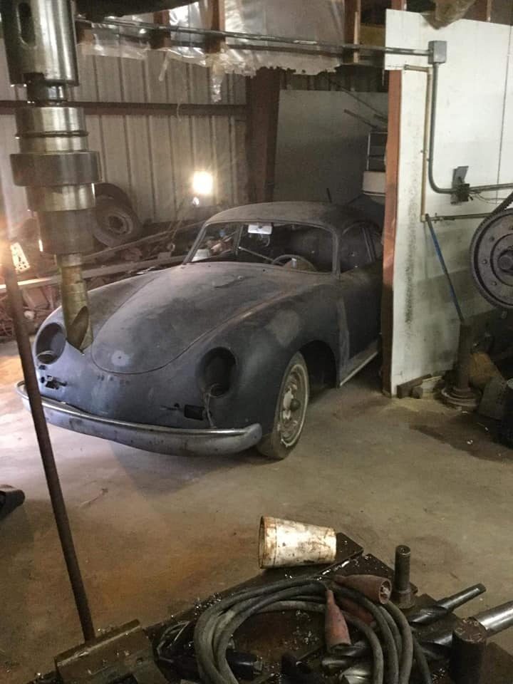 Inside the Needville machine shop, the 356 parked among tools and shelving