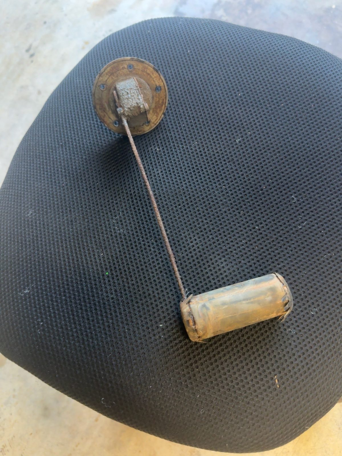 Fuel sender removed from the tank, swing arm and float visible