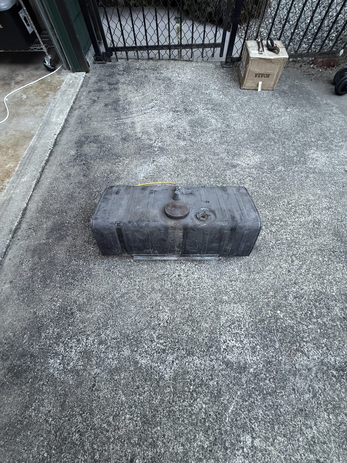 Fuel tank removed, sitting on the driveway, top view
